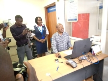 Hon Minister of State for finance Amos Lugolobi crediting PDM money on Beneficiaries accounts in Centenary Bank Kayunga District